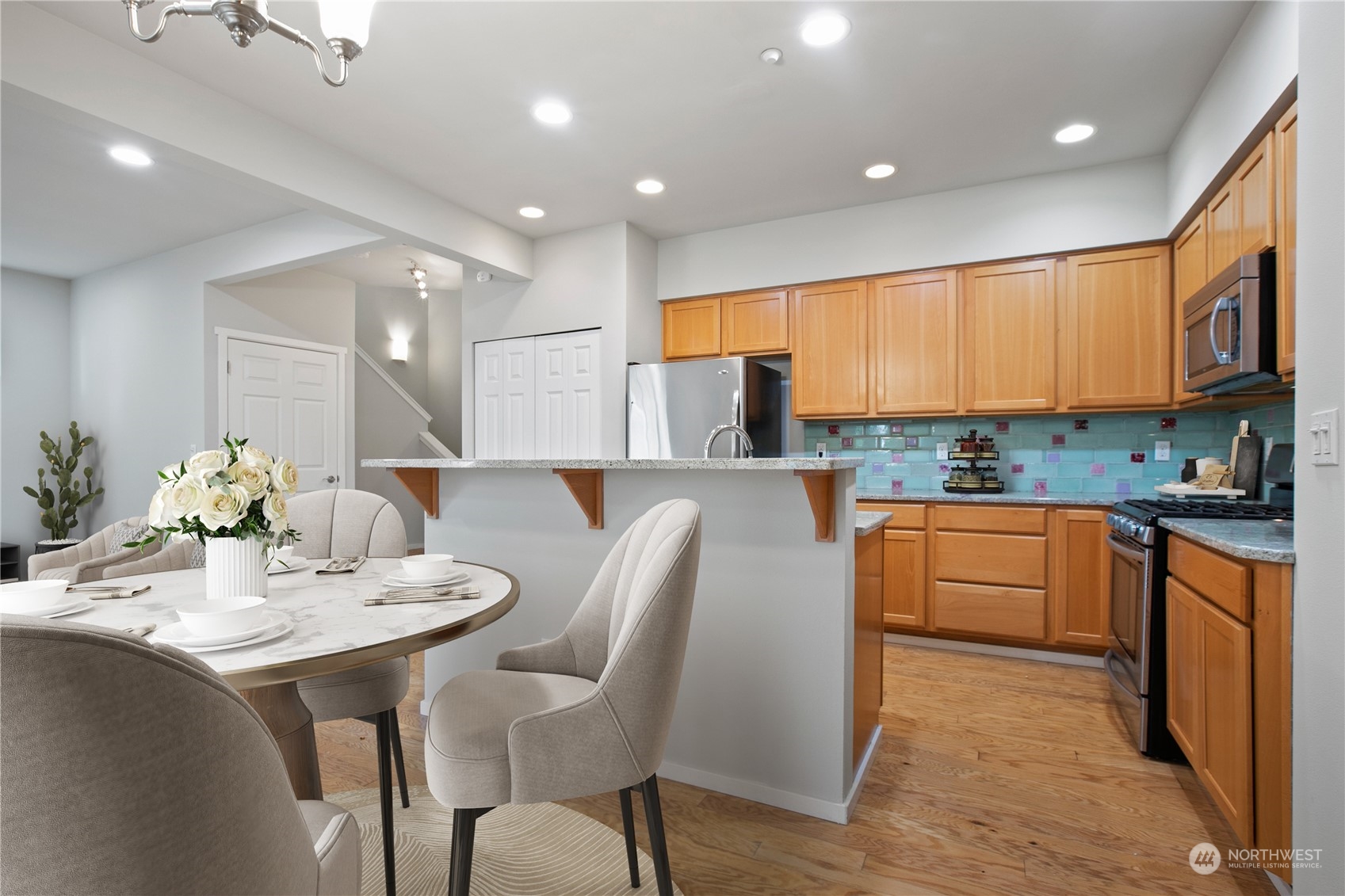 20734 76th Avenue West, Unit D Edmonds, WA 98026 - Photo 8 of 32 a kitchen with stainless steel appliances kitchen island granite countertop a sink and cabinets