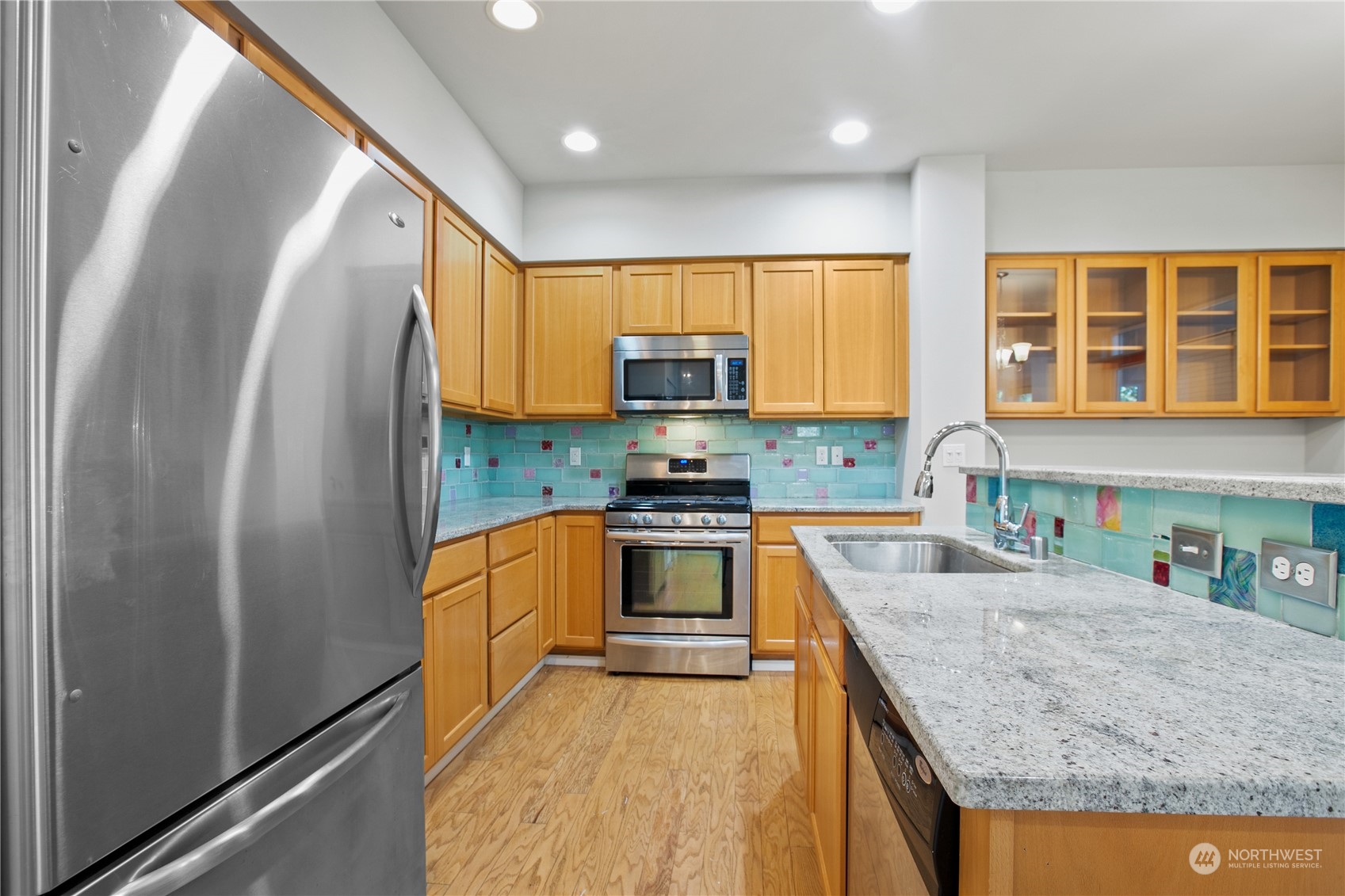 20734 76th Avenue West, Unit D Edmonds, WA 98026 - Photo 9 of 32 a kitchen with granite countertop a stove a sink and a refrigerator