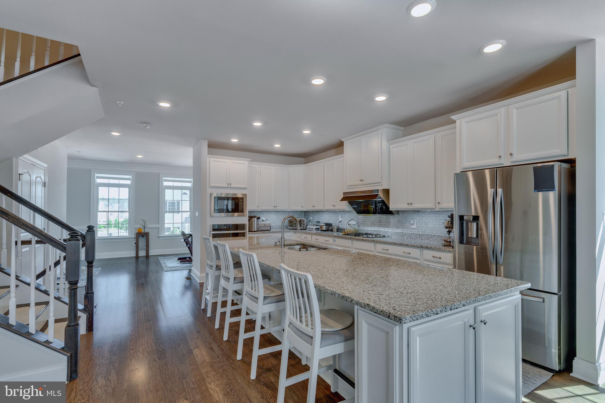 837 Stonecliffe Road Malvern, PA 19355 - Photo 3 of 12 an open kitchen with kitchen island and stainless steel appliances