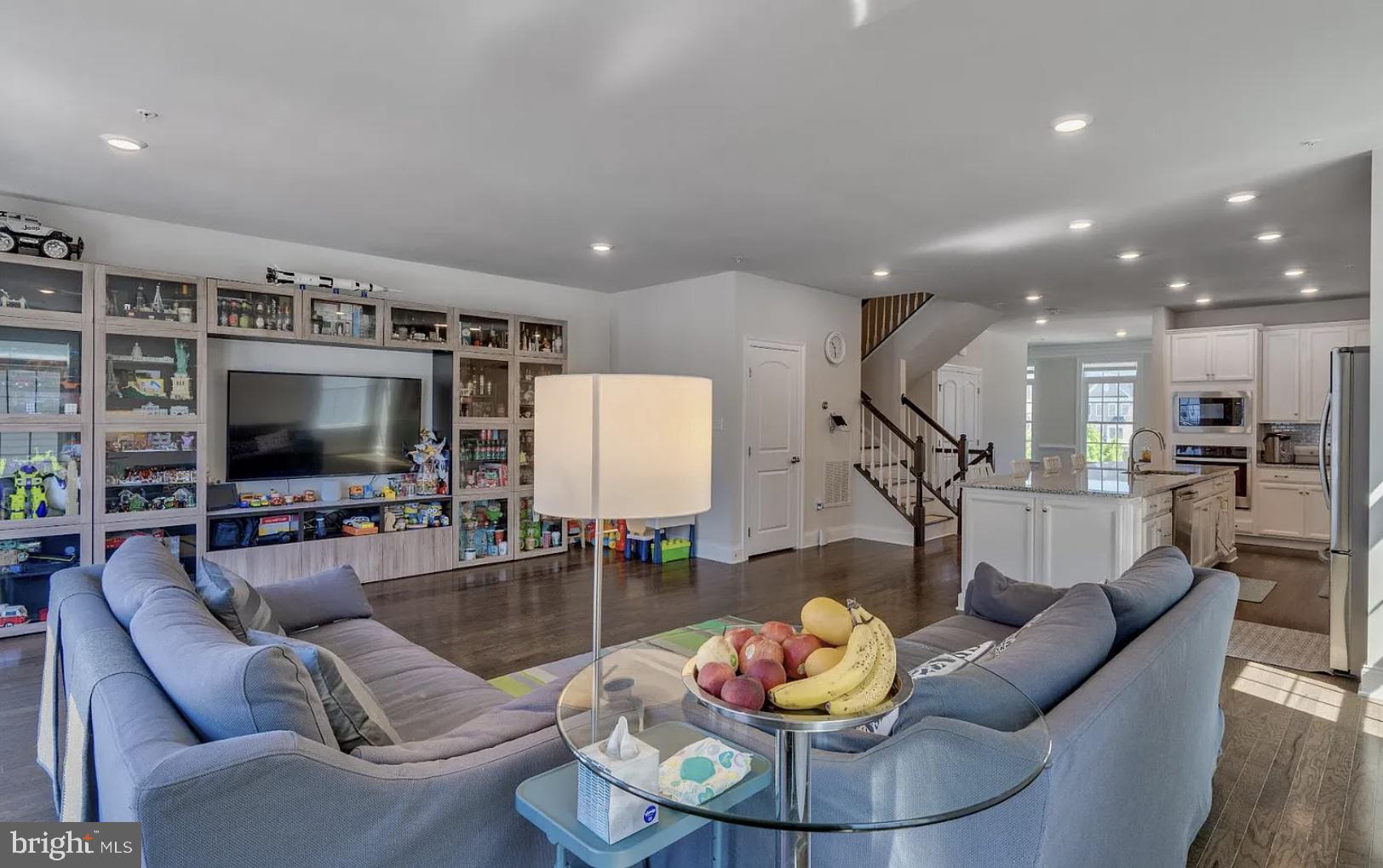 837 Stonecliffe Road Malvern, PA 19355 - Photo 5 of 12 a living room with furniture kitchen view and a flat screen tv