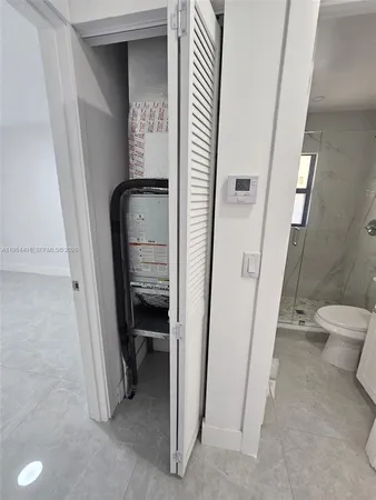 a view of a hallway with toilet and a hallway