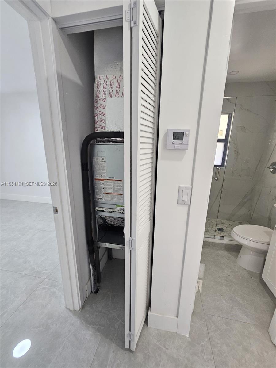 1148 Northwest 100th Street, Unit 2 Miami, FL 33150 - Photo 12 of 22 a view of a hallway with toilet and a hallway