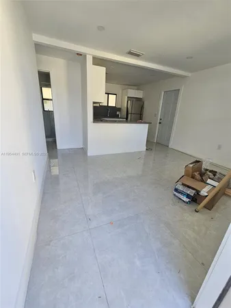 a view of kitchen and refrigerator