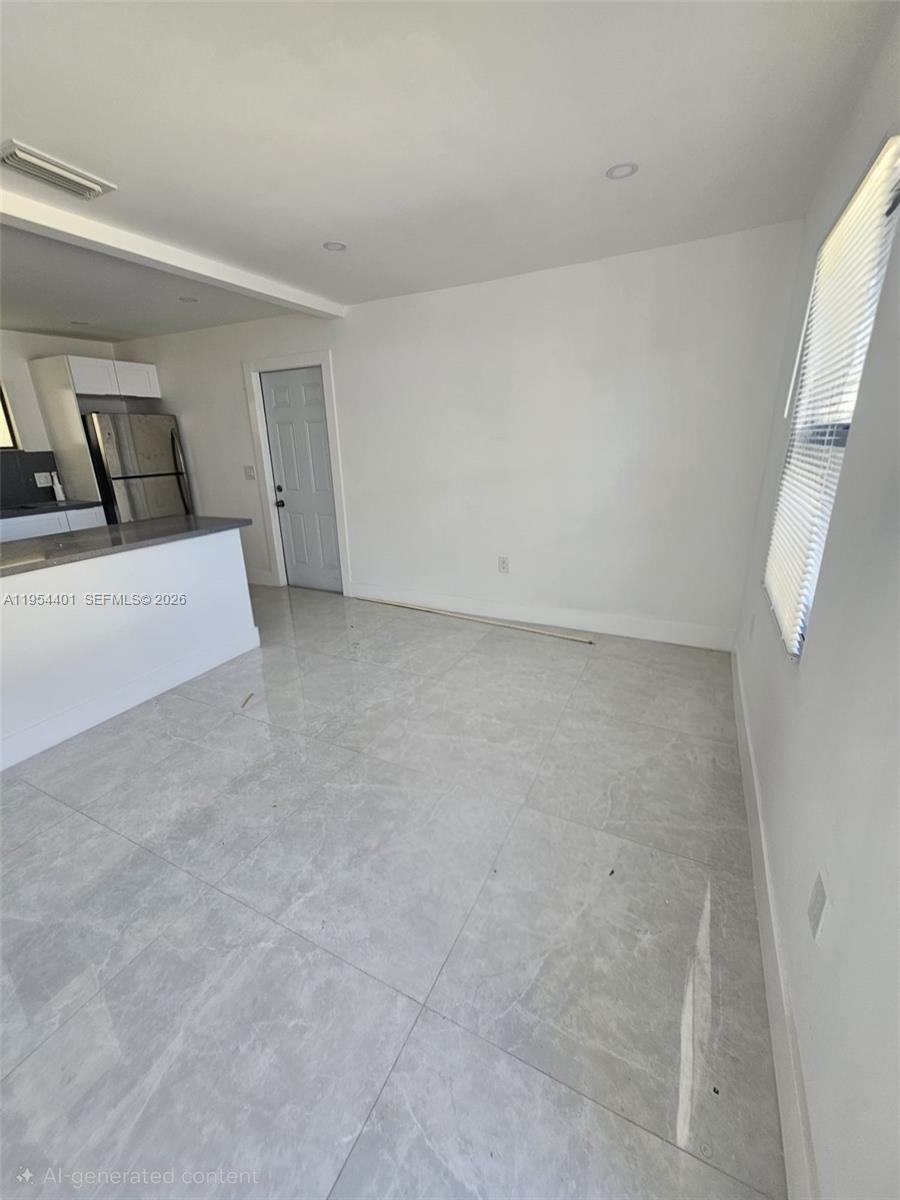 1148 Northwest 100th Street, Unit 2 Miami, FL 33150 - Photo 3 of 22 a view of a room with white walls