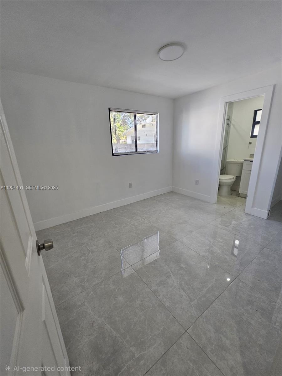 1148 Northwest 100th Street, Unit 2 Miami, FL 33150 - Photo 8 of 22 an empty room with windows