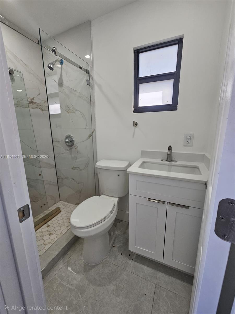1148 Northwest 100th Street, Unit 2 Miami, FL 33150 - Photo 9 of 22 a bathroom with a sink toilet and shower
