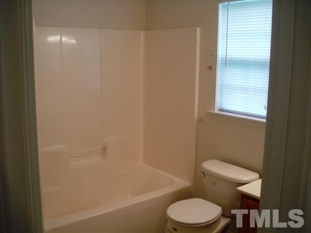2544 Ross Road Durham, NC 27703 - Photo 13 of 15 a white toilet sitting next to a bath tub