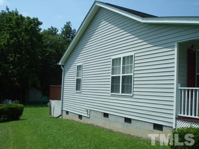 2544 Ross Road Durham, NC 27703 - Photo 4 of 15 a view of a house with a yard and a garage