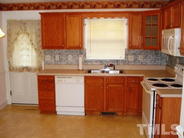 2544 Ross Road Durham, NC 27703 - Photo 7 of 15 a kitchen with stainless steel appliances granite countertop a sink stove and cabinets