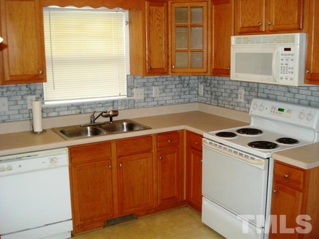 2544 Ross Road Durham, NC 27703 - Photo 9 of 15 a kitchen with a sink a stove and cabinets