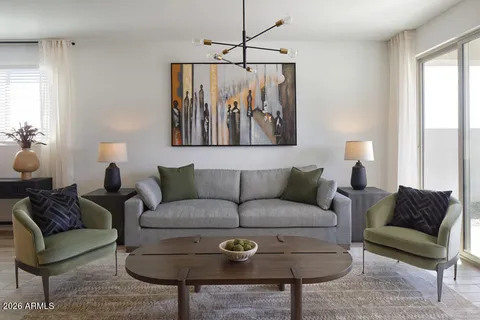 a living room with furniture a couch and a window