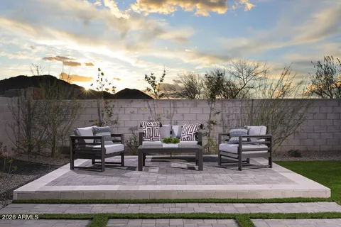 a view of backyard with seating area and green space