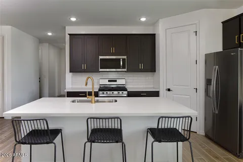 a kitchen with stainless steel appliances a microwave sink and refrigerator