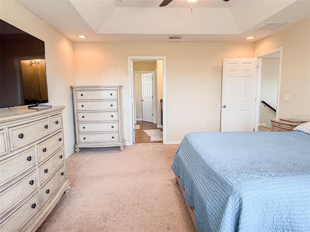 8607 Randal Park Boulevard Orlando, FL 32832 - Photo 29 of 51 a bedroom with a bed and flat screen tv