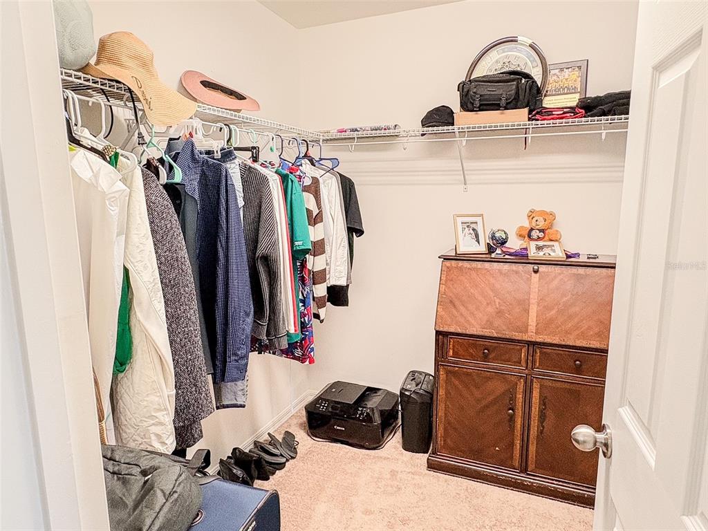 8607 Randal Park Boulevard Orlando, FL 32832 - Photo 31 of 51 a view of walk in closet with clothes and shoes