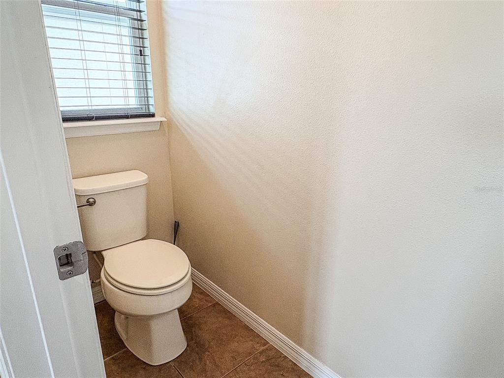 8607 Randal Park Boulevard Orlando, FL 32832 - Photo 32 of 51 a white toilet sitting next to a window