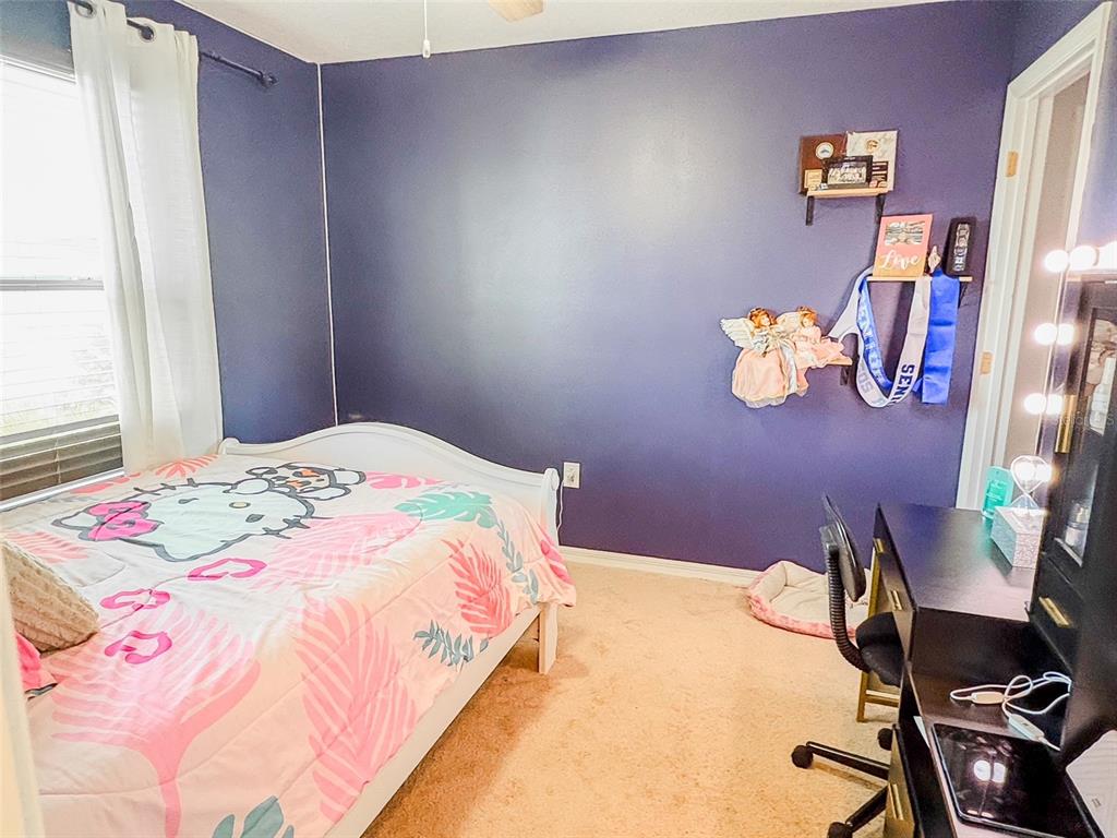 8607 Randal Park Boulevard Orlando, FL 32832 - Photo 38 of 51 a bedroom with a bed and wooden floor