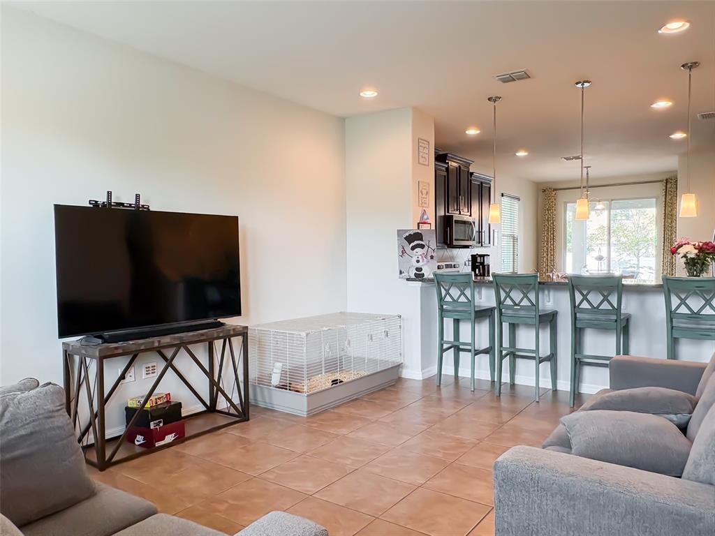 8607 Randal Park Boulevard Orlando, FL 32832 - Photo 5 of 51 a living room with furniture and a flat screen tv