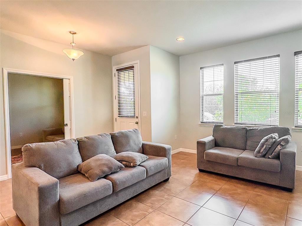8607 Randal Park Boulevard Orlando, FL 32832 - Photo 6 of 51 a living room with furniture and a large window
