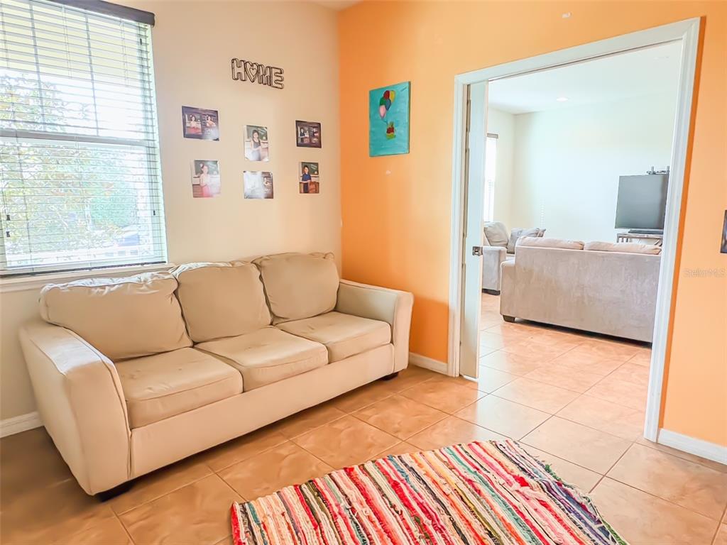 8607 Randal Park Boulevard Orlando, FL 32832 - Photo 8 of 51 a living room with furniture and a window