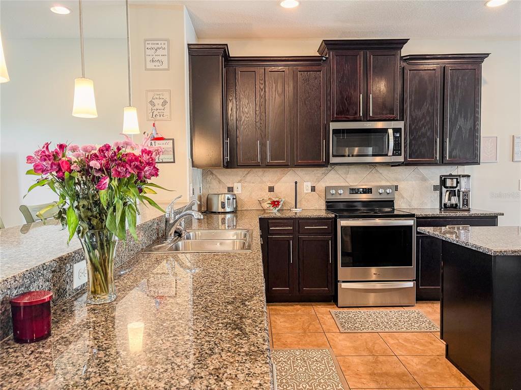 8607 Randal Park Boulevard Orlando, FL 32832 - Photo 10 of 51 a kitchen with a sink stove and microwave
