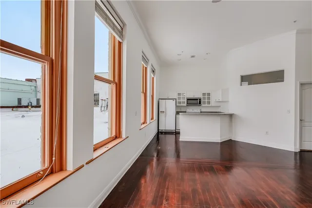 a kitchen with stainless steel appliances granite countertop a sink a microwave stove and refrigerator