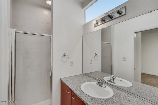 an empty room with closet and a chandelier fan