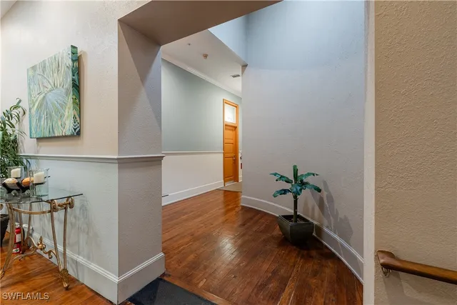 a living room with furniture and flowers with potted plants
