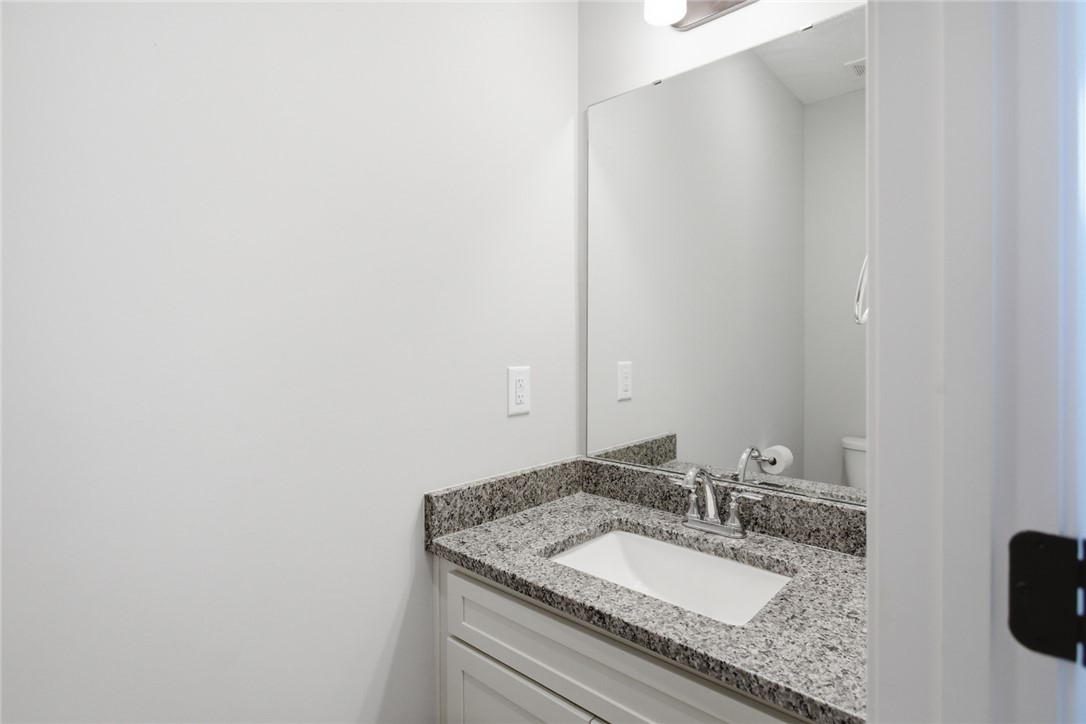 912 Watercrest Road West Union, SC 29696 - Photo 15 of 49 This sleek bathroom features a vanity with a granite countertop, creating a clean and modern aesthetic.