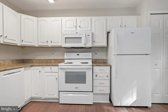 a kitchen with cabinets appliances a sink and a counter space