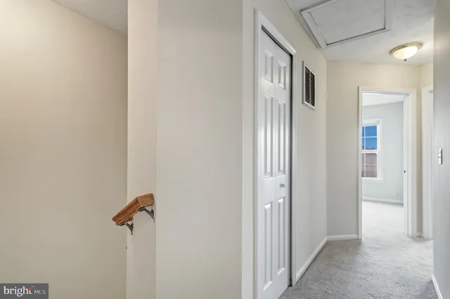 a view of a hallway with a door