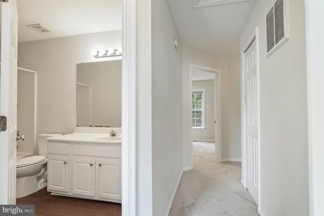 a en suite bathroom with a sink double vanity and a mirror