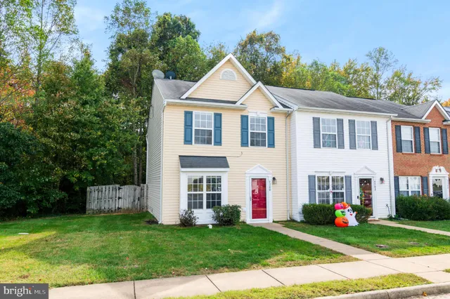 a view of a white house with a yard and plants