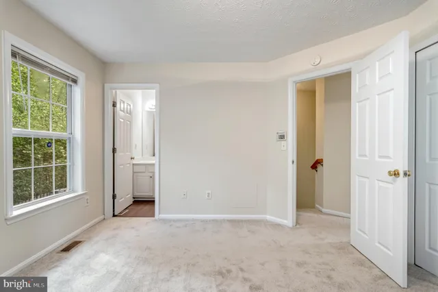 an empty room with windows and closet