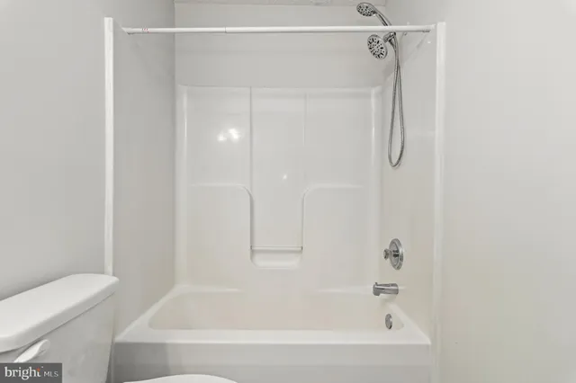 a bathroom with a shower and a bath tub