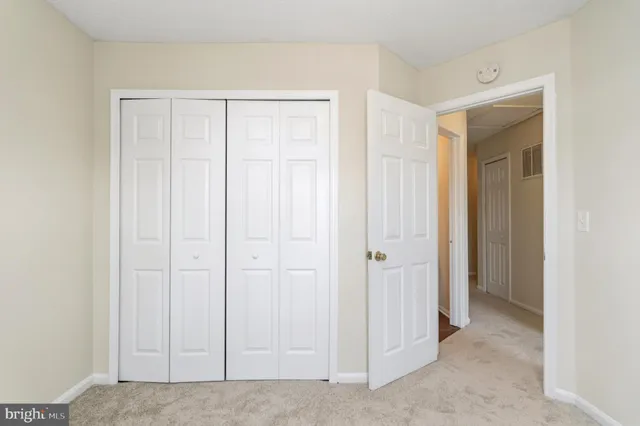 an empty room with closet area
