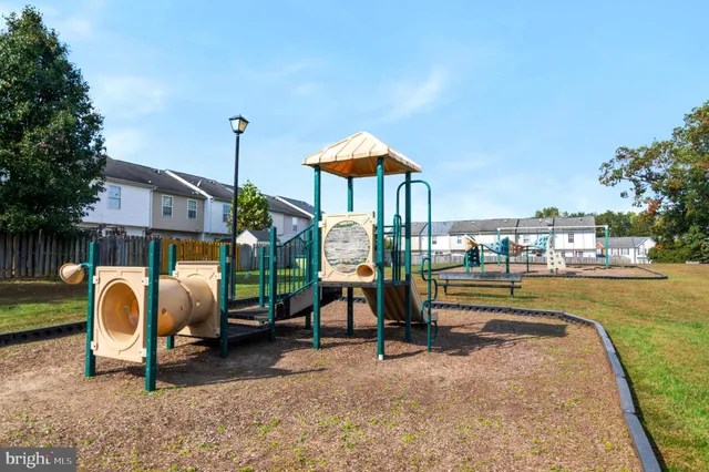 a view of a swimming pool with a slide and bench