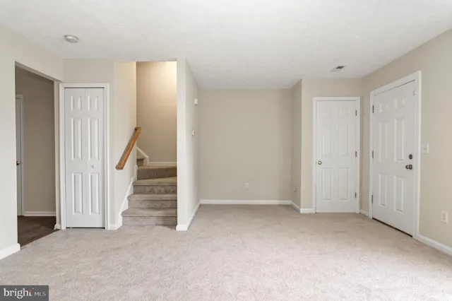 a view of an empty room with stairs