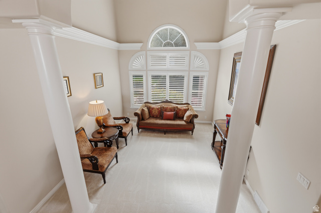 11943 Autumn Ridge Drive East Sandy, UT 84092 - Photo 7 of 59 Living area with decorative columns, light carpet, and a high ceiling