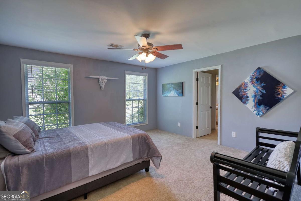 947 Bellhouse Road Macon, GA 31217 - Photo 24 of 100 a bedroom with a bed and a chandelier