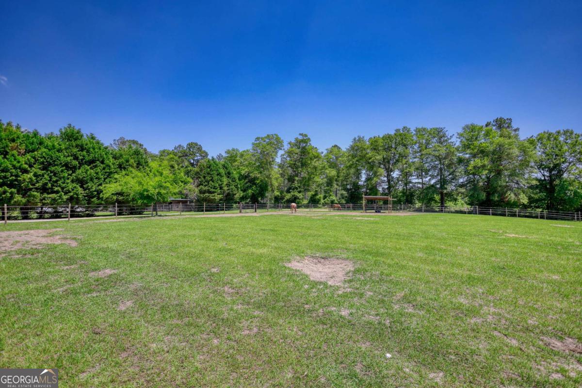 947 Bellhouse Road Macon, GA 31217 - Photo 87 of 100 a view of a green field with trees in the background