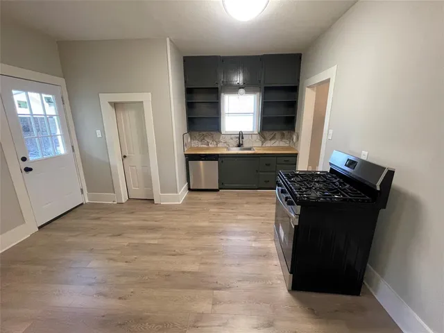 a kitchen with stainless steel appliances granite countertop a refrigerator and a stove