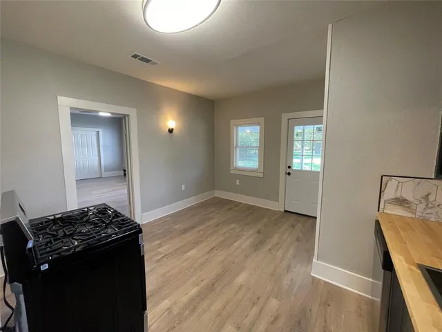 a view of a kitchen cabinets and a stove