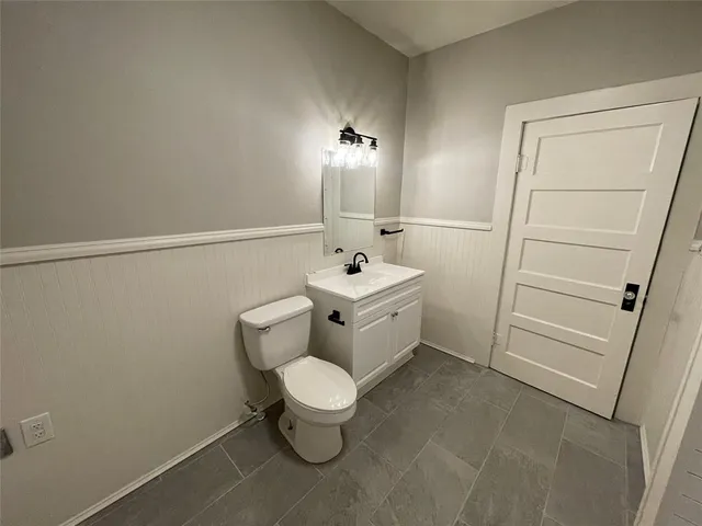 a bathroom with a toilet sink and vanity
