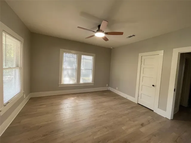 wooden floor in an empty room with a window