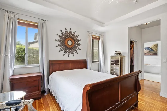 a bathroom with a double vanity sink mirror and bathtub
