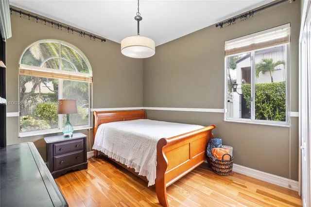 a kitchen with stainless steel appliances granite countertop a sink dishwasher and cabinets with wooden floor