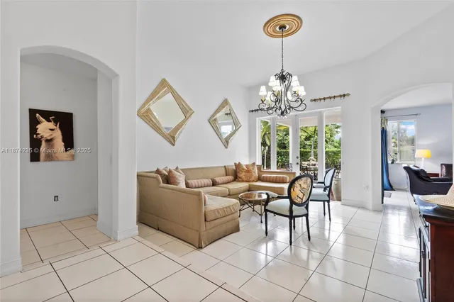 a living room with furniture and a chandelier