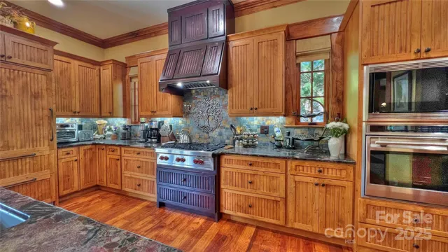 a view of a dining room with furniture a chandelier and wooden floor