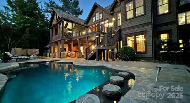 a swimming pool with outdoor seating and yard